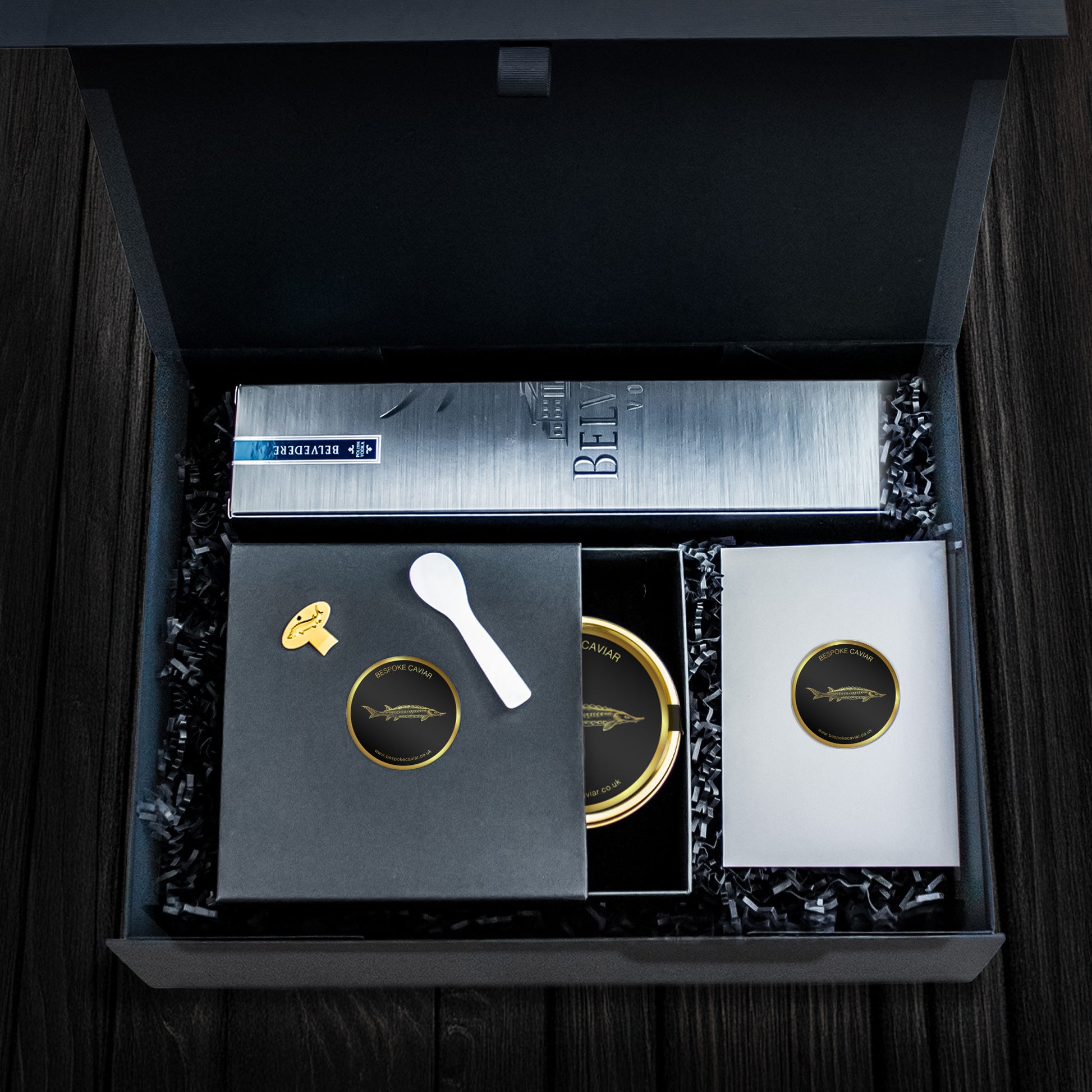 Dark hamper featuring Belvedere vodka, caviar tin, mother of pearl spoon and a caviar tin opener